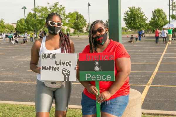 Marchers at Victory's Peace March holding signs